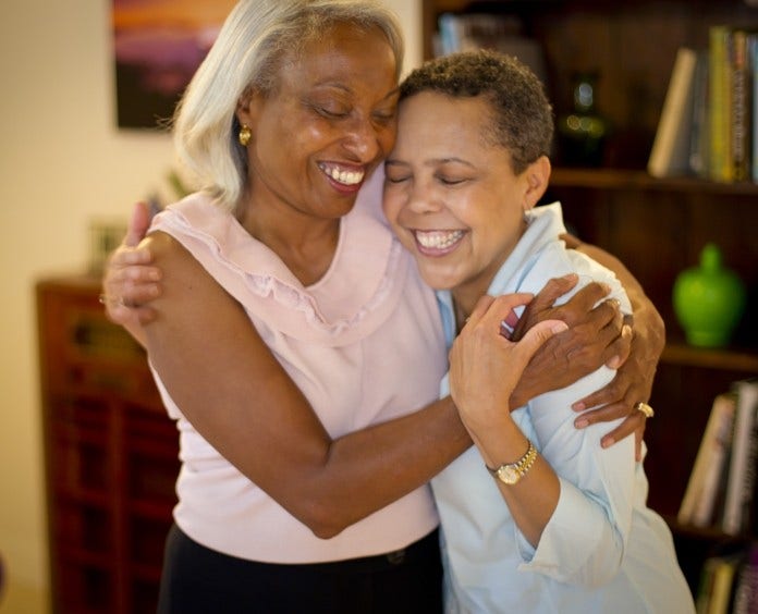 two happy women embracing
