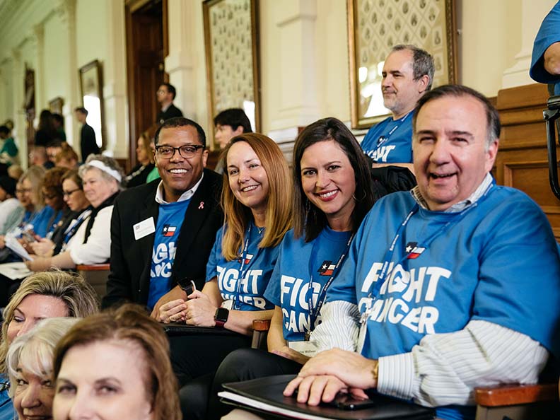 group of people wearing blue fight cancer t-shirts